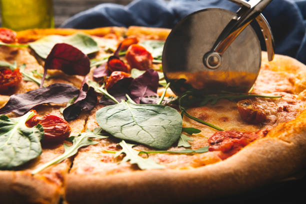 Cutting Homemade Pizza pizza close up pizza cutter stock pictures, royalty-free photos & images