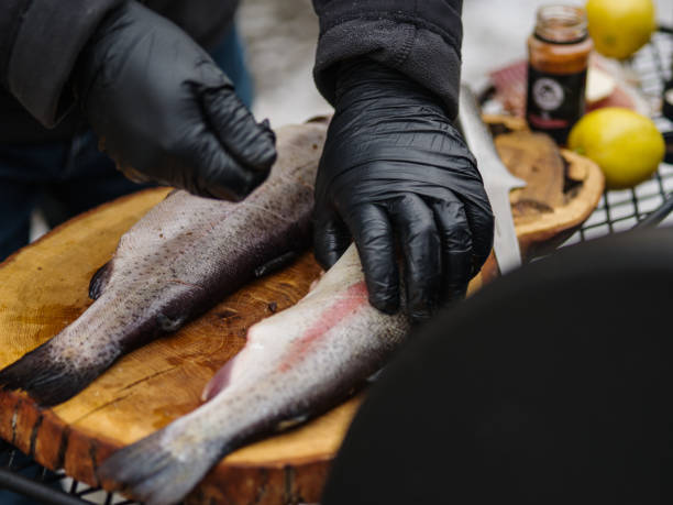 istock Grillman prepares trout for grilling. 1303785865
