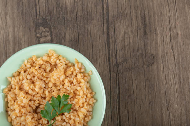 istock Delicious bulgur with greens on a green plate 1303787004