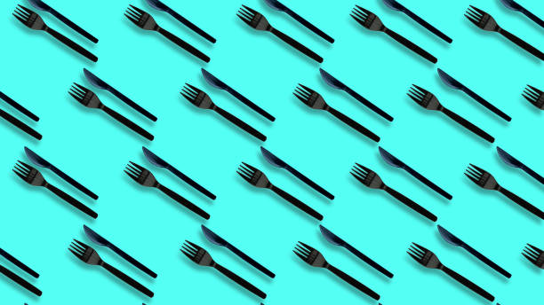 istock black Plastic forks and cutlery on pastel colors 1303788042