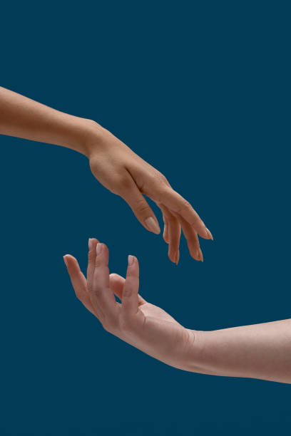 istock Close up of two open female hands with empty space between them reaching each other isolated over blue background 1303790758