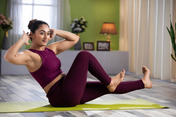 Beautiful attractive young woman doing yoga exercising at home, Health concept, Fitness concept, stock photo Beautiful attractive young woman doing yoga exercising at home waist training stock pictures, royalty-free photos & images