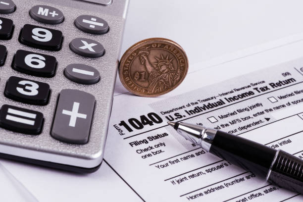istock Tax Form 1040 and money 1303792983