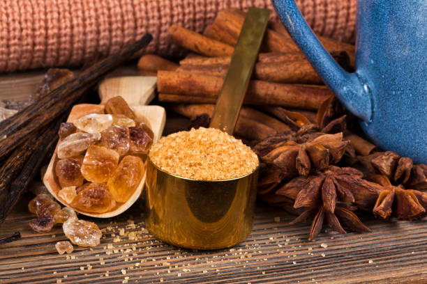 istock Cinnamon, anise, vanilla and brown sugar with stack of knits 1303799230