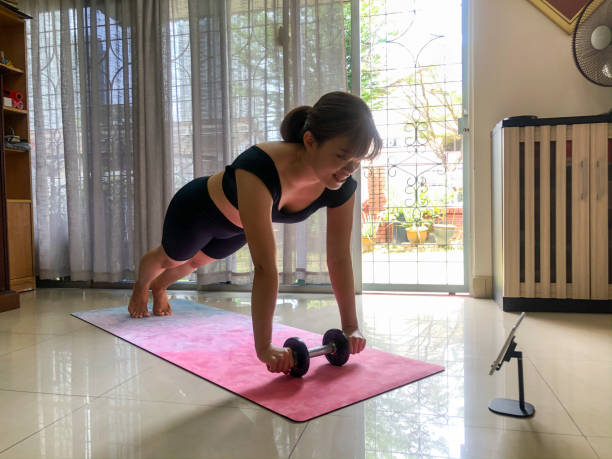 istock An Asian woman making exercise via livestream videos classes on digital tablets 1303799728