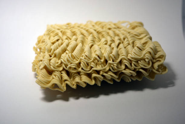 istock Instant vermicelli, briquette of thin, long vermicelli set on a white background. 1303801035
