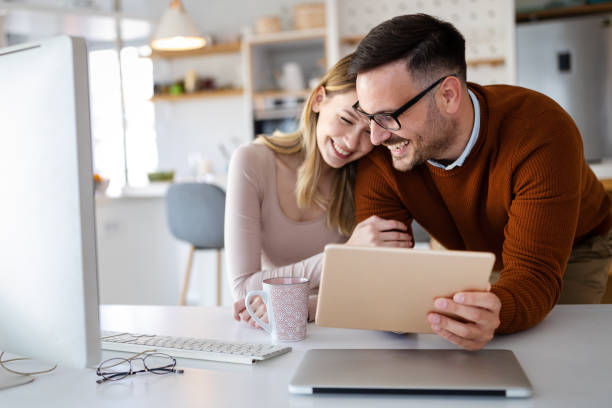 istock Beautiful couple working on a tablet at home 1303801053