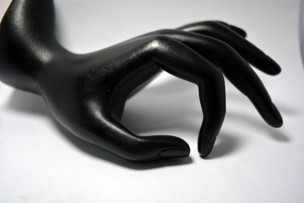 istock Ceramic, clay female hand covered with black matte paint is located on a white background. 1303801074