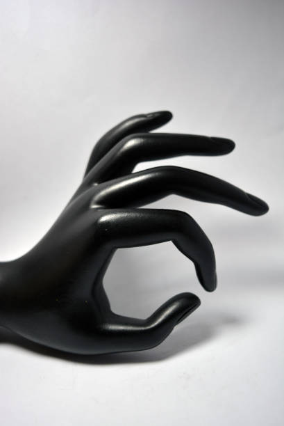 istock Ceramic, clay female hand covered with black matte paint is located on a white background. 1303801078