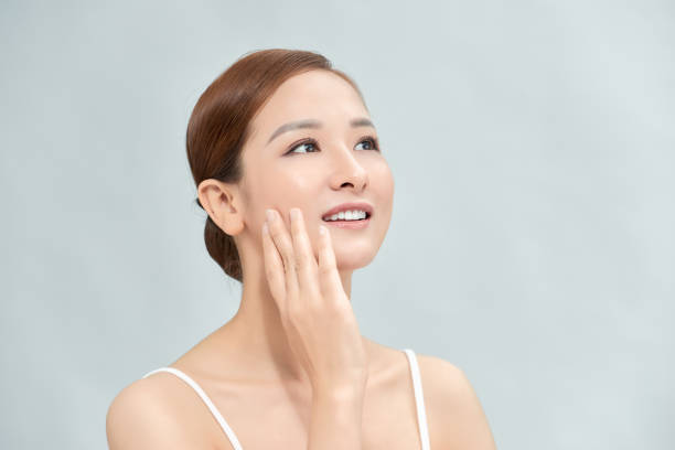 istock Cleansing young woman on blue background 1303801268