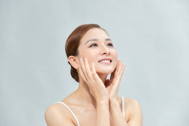 istock Charming beautiful young asian woman touching face 1303801939