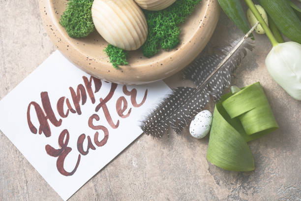 istock Easter composition with wooden Easter eggs and spring flowers  tulips on concrete background. Easter card close up 1303804028