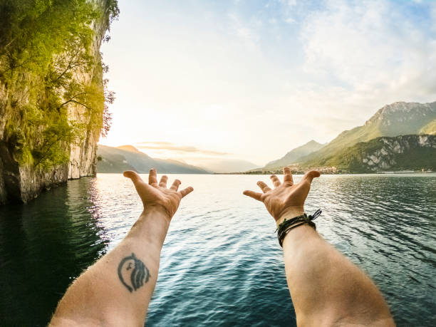 istock Man showing lake panorama with hands, point of view wide angle 1303804465