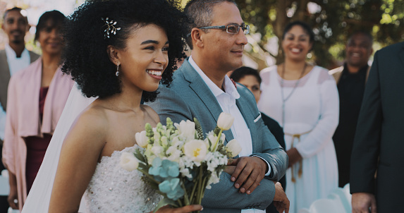 Cropped shot of an attractive young bride walking down the isle with her father on her wedding day