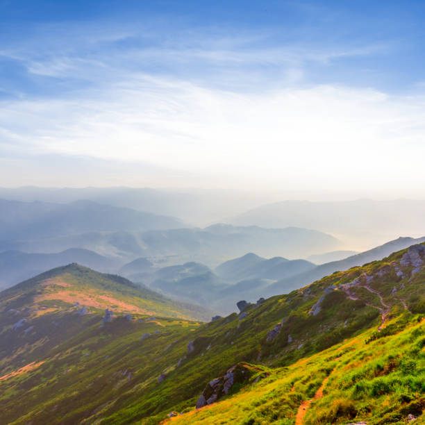 istock sunset over a green mountain valley 1303805519