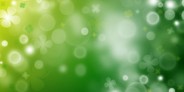 istock St Patrick's day illustration, clover leafs rotating on the green background 1303806052