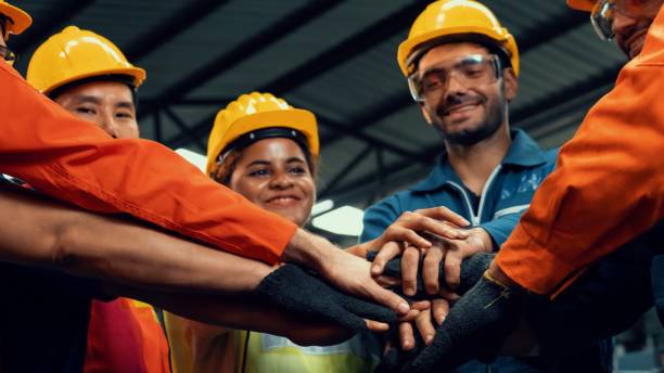 istock Skillful worker stand together showing teamwork in the factory . 1303806433