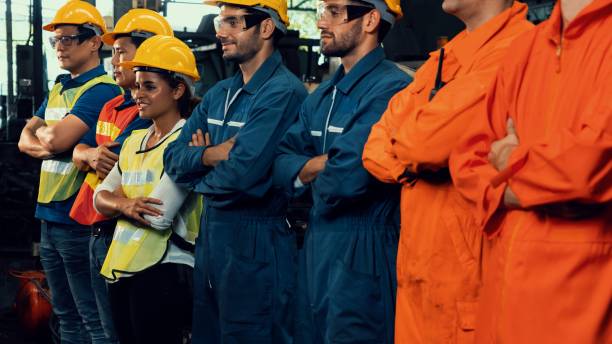 istock Skillful worker stand together showing teamwork in the factory . 1303806525