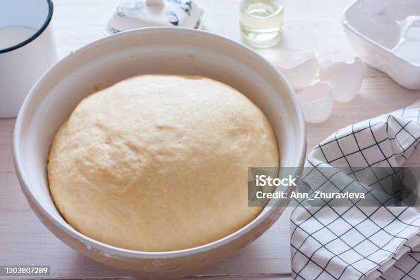 Freshly Cooked Yeast Dough In Ceramic Bowl On White Wooden Table Selective Focus Stock Photo - Download Image Now