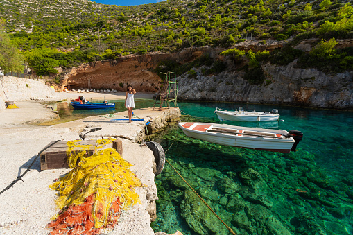 Beautiful tourist sitting on top having fun and enjoying vacations in  Zakynthos Greece