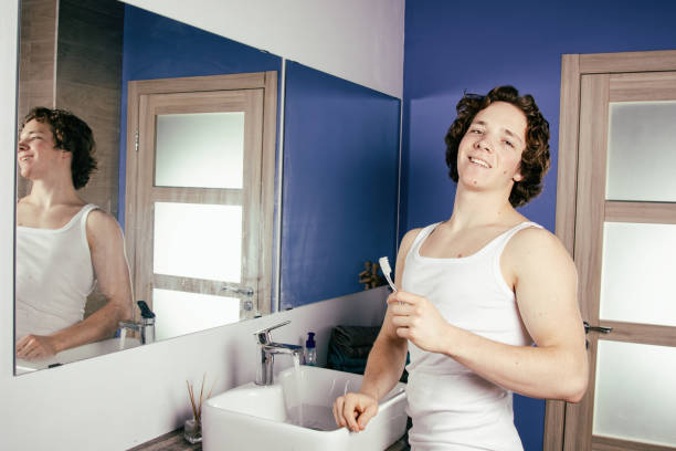 istock Handsome young man in the bathroom. 1303807478