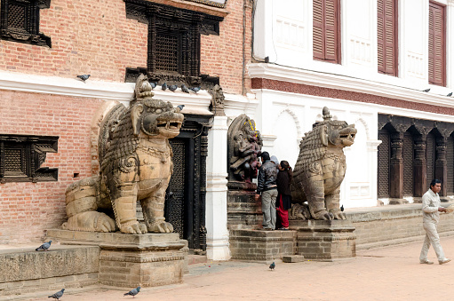 Bhaktapur, Nepal - February 15, 2015: Locals at the entrance of the National Art Museum in Bhaktapur Durbar Square, Nepal