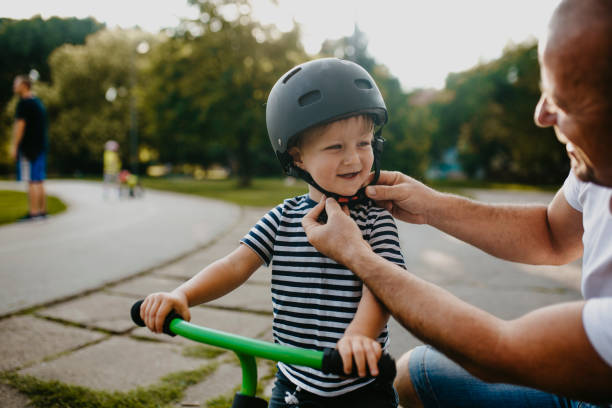 Little boy learning to ride a bicycle stock photo