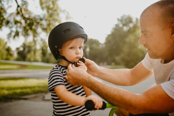 istock Little boy learning to ride a bicycle 1303808990