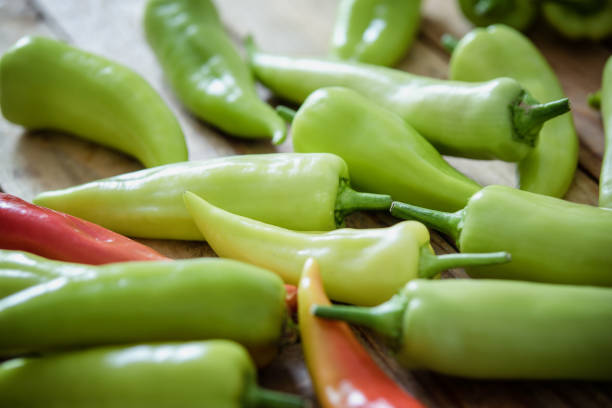 istock Chili peppers on wood board, close up 1303809295