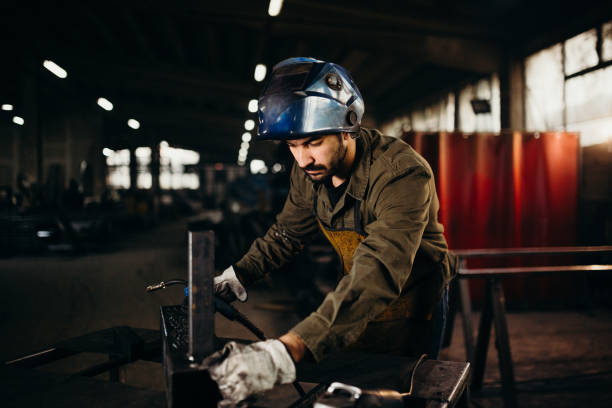 istock Welder working in a factory 1303810369
