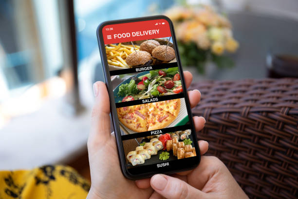 istock female hands hold phone with food delivery application on screen 1303810862