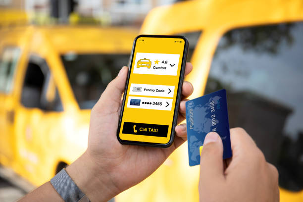 istock man hands holds phone with taxi call application on screen 1303811206