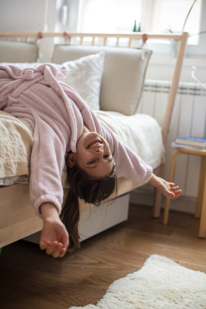 istock Little happy girl on her bed in bathrobe. 1303811786