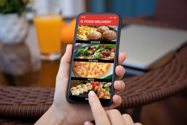 istock female hands hold phone with food delivery application on screen 1303812098
