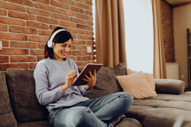 istock enjoy the afternoon on the sofa with good music 1303813245