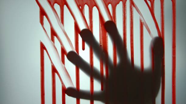 istock Male Hand Behind Translucent Glass Leaving Blood Marks on the Surface 1303813745