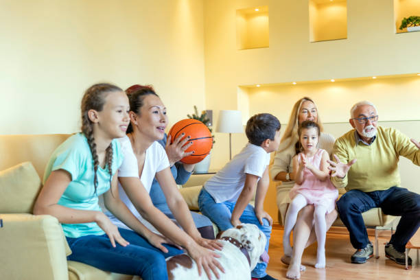istock Enthusiastic Large Family is Supporting Basketball Team from Home. 1303822921