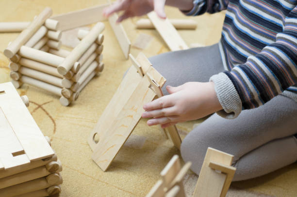istock Child plays with a wooden construction set 1303823151
