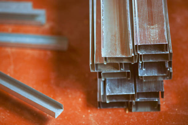 istock A stack of new drywall profiles on the dirty orange floor 1303823643