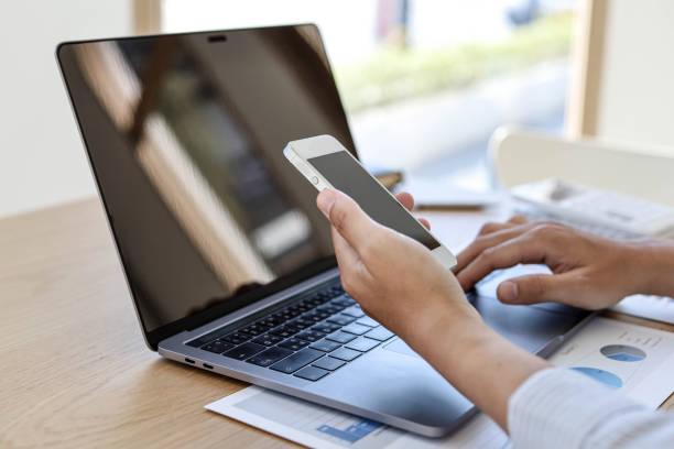 istock A man with a mobile phone And use the laptop. 1303824705