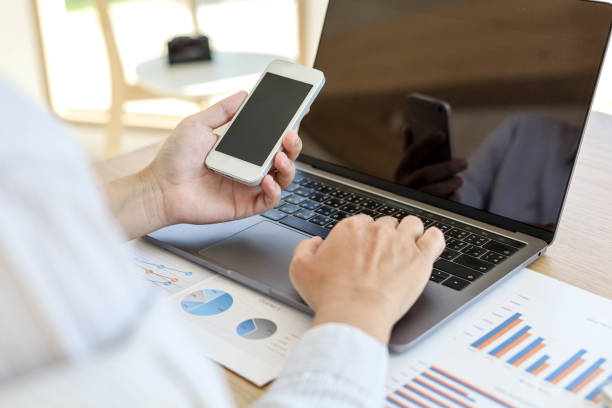 istock A man with a mobile phone And use the laptop. 1303824866