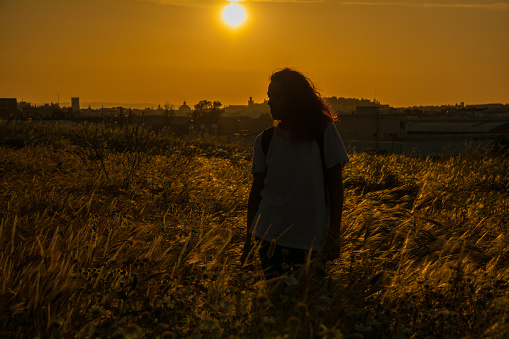 Young Woman Enjoying A Walk Through A Field. Spring Concept