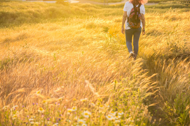 istock Unrecognizable Woman Walking Across The Field. 1303826374