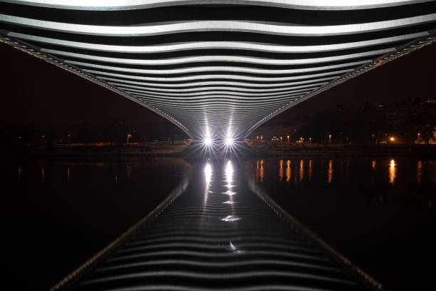 abstract river reflection under the bridge with lights. futuristic bridge above the river. diminishing perspective - prague mirrored pattern bridge architecture imagens e fotografias de stock