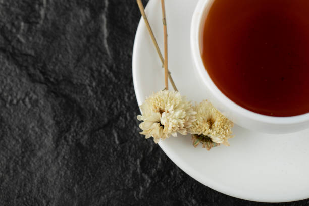 istock A cup of tea with dried flowers on a black background 1303827743