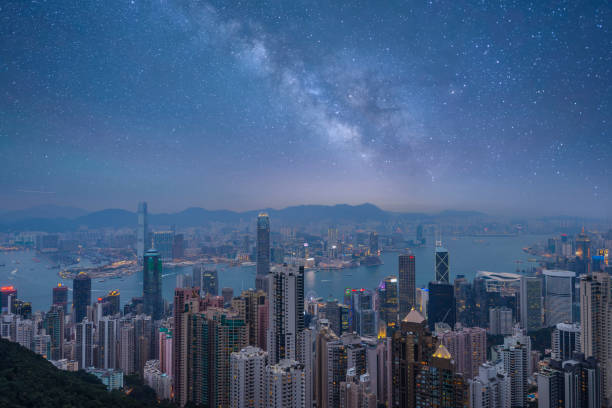 Hong Kong Skyline Harbour Illuminated at Twilight Vertical Some of Hong Kong's tallest buildings, including IFC2, seen from The Peak of Hong Kong Island at twilight. central plaza hong kong stock pictures, royalty-free photos & images