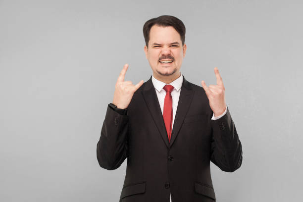 istock Businessman showing rock and roll sign 1303829961