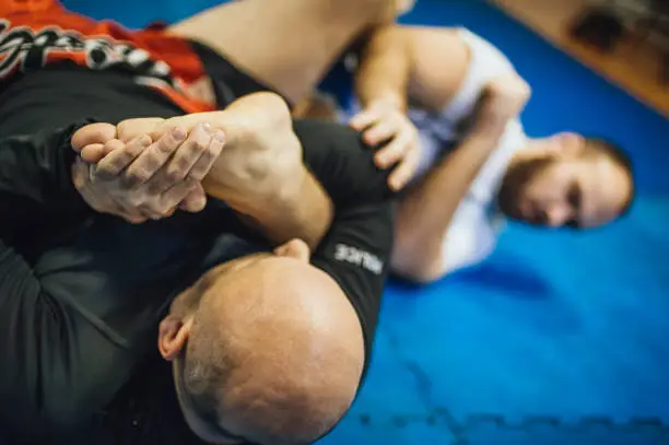 BJJ Brazilian jiu-jitsu ground fight training combat sparing. Leg ankle foot lock submission control technique
