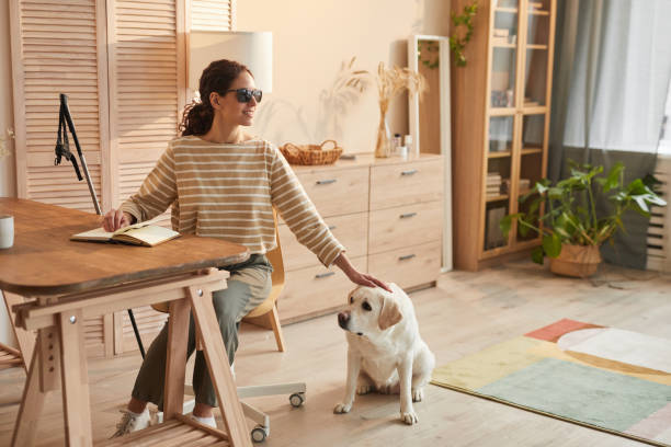 istock Blind Woman with Guide Dog at Home 1303834105