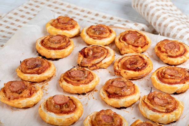 istock Puff pastry cakes with sausage, cheese and bacon 1303835585